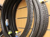 two tires hanging on the wall of a bike shop