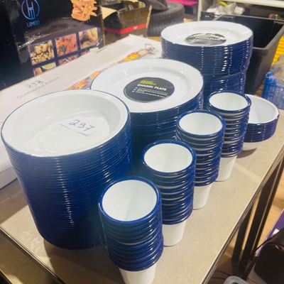 a lot of blue and white plates and cups on the table