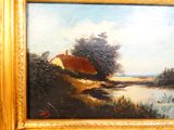 an oil painting of a house by a river in a golden frame