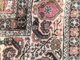 a close up of a rug on a wooden floor