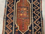 an old rug is laying on the floor next to a wall