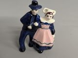 a figurine of a man and a woman standing next to each other