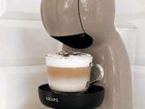 a coffee machine that has a cup of coffee in it