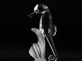 a black and white seahorse figurine on a black background