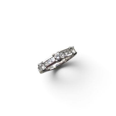 a close up of a diamond ring on a white surface