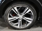 a close up of a tire on a car in a showroom