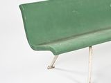 a green bench that is sitting on a white surface