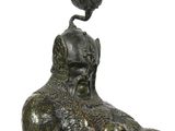 a statue of a man riding a horse with a bird on top of his head