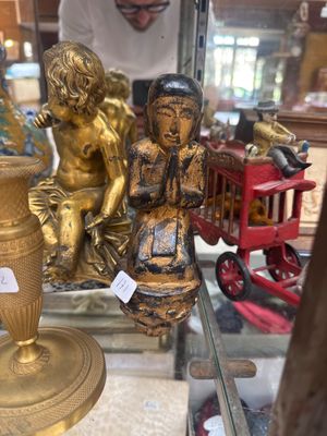 a gold statue of a boy and a girl sitting on a table