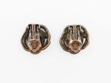 a pair of silver earrings with a brown stone in the middle