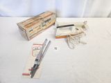 a box of scissors and a pair of scissors on a table