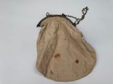an old purse with a chain hanging from it ' s side