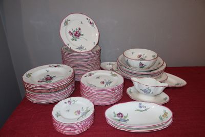 a lot of plates and bowls on a red table