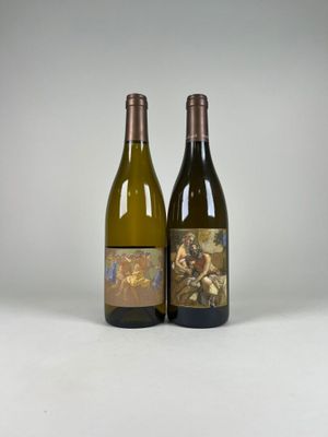 two bottles of wine sitting next to each other on a white surface