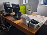 a desk with two computers and a printer on it