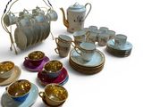 many cups and saucers that are sitting on the table