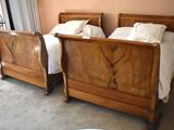 two beds that are made up in a room
