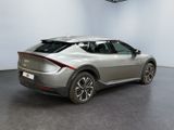 the rear end of a silver car in a room with white walls