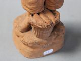 a clay figurine of a teddy bear holding a basket