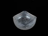 a glass bowl that is sitting on a black surface
