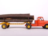 a toy truck with logs on the back of it