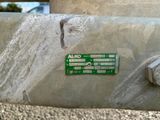 a close up of a metal object with a green label on it