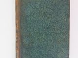 a green book sitting on top of a white table