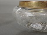 a glass jar with a gold lid on a table
