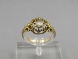 an image of a gold ring with a white diamond in the center