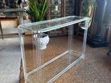 a glass table with a plant in it in a living room