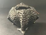 a close up of a small animal figurine on a table