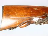 a close up of a rifle on a white background