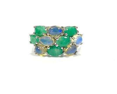 a close up of a green and blue ring on a white surface