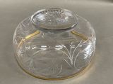 a clear glass jar with a gold rim on a table