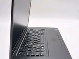 a laptop computer sitting on a table with a keyboard