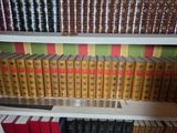 many books that are on a shelf in a library