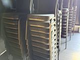 many chairs that are stacked up together in a room