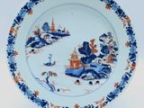 a blue and white plate with an oriental scene on it