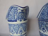 two blue and white vases sitting next to each other