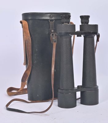 an old pair of binoculars sitting next to each other on a white surface