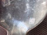 a close up of a silver spoon with a tag on it