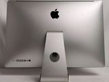 an apple computer sitting on top of a white table