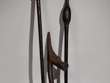 pair of old wooden and metal tools on a white surface