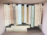 many books that are stacked in a box together