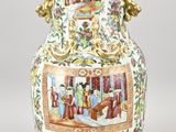 a large vase with a painting on it sitting on a table