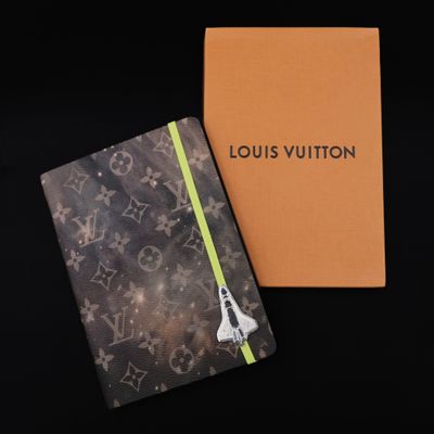 a louis vuitton notebook with a space shuttle on it