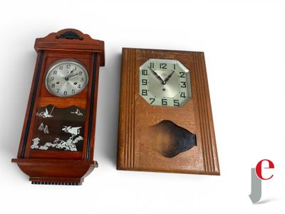two clocks sitting next to each other on a white surface