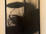 a black and white photo of a painting on the wall