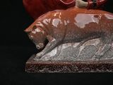 a figurine of a bear and a pig on a black background