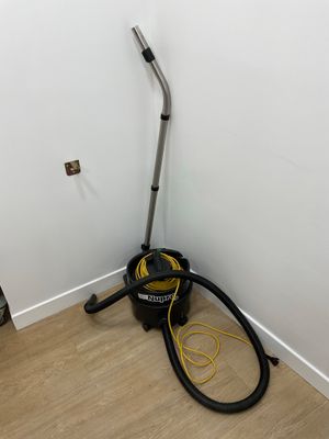 a vacuum that is sitting in the corner of a room